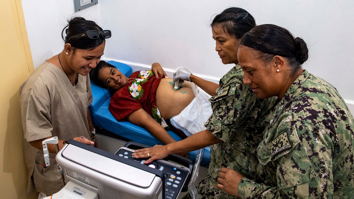 Cmdr. Angelita Kisena, right, Cmdr. Cheryl Castro, second from right, and Mev Erson, community worker, left, conduct an ultrasound on a patient at Chuuk Community Health Center, during Pacific Partnership 2025 in Chuuk, Aug. 22, 2025. Now in its 21st iteration, the Pacific Partnership series is the largest annual multinational humanitarian assistance and disaster management preparedness mission conducted in the Indo-Pacific. Pacific Partnership works collaboratively with host and partner nations to enhance regional interoperability and disaster response capabilities, increase security and stability in the region, and foster new and enduring friendships in the Indo-Pacific. (U.S. Navy photo by Mass Communication Specialist Seaman Mario E. Reyes Villatoro)