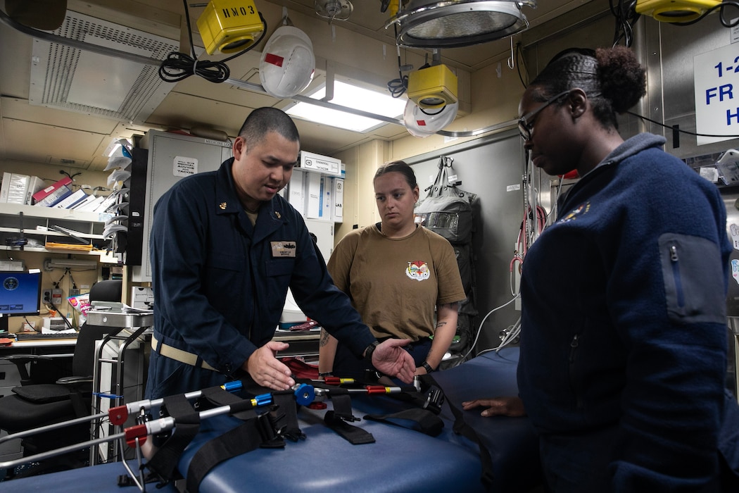 250722-N-VM650-1031 U.S. CENTRAL COMMAND AREA OF RESPONSIBILITY (July 22, 2025) A U.S. Navy Chief Hospital Corpsman explains the use of the traction splint during medical training aboard the Arleigh Burke-class guided-missile destroyer USS Wayne E. Meyer (DDG 108) in the U.S. Central Command area of responsibility. (Official U.S. Navy photo)