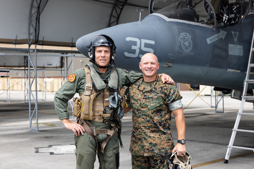 U.S. Marine Corps Lt. Gen. Eric Austin, left, from Oregon, deputy commandant of Combat Development and Integration (CD&I), and Sgt. Maj. Ryan N. McCrary, from Virginia, command senior enlisted leader, Marine Attack Squadron (VMA) 223, Marine Aircraft Group 14, 2nd Marine Aircraft Wing (MAW), pose for a photo at Marine Corps Air Station Cherry Point, North Carolina, Aug. 28, 2025. Austin visited Marines and Sailors from VMA-223 to gain insight on the internal workings of the squadron and observe maintainer and pilot proficiency and expertise with the AV-8B Harrier II. (U.S. Marine Corps photo by Lance Cpl. Orlanys Diaz Figueroa)