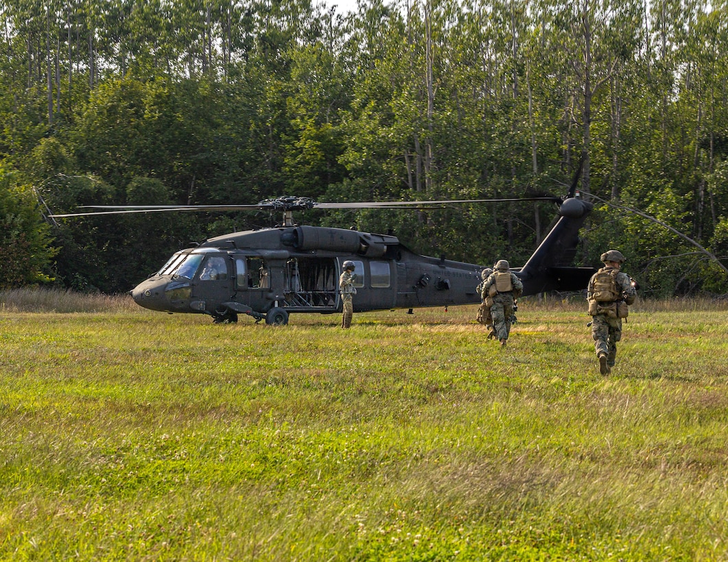 U.S. Marines with Charlie Company, 1st Battalion, 24th Marine Regiment, 4th Marine Division, run to a U.S. Army Sikorsky UH-60 Black Hawk for exfiltration after conducting offensive raid training event for Training exercise Northern Strike 25-2 at Camp Grayling, Michigan, Aug. 9, 2025. Northern Strike, held Aug. 2 to 16, 2025, is designed to validate readiness of Joint Reserve forces at the National All-Domain Warfighting Center. This year's iteration featured approximately 7,500 participants. (U.S. Marine Corps photo by Cpl. Aaron TorresLemus)