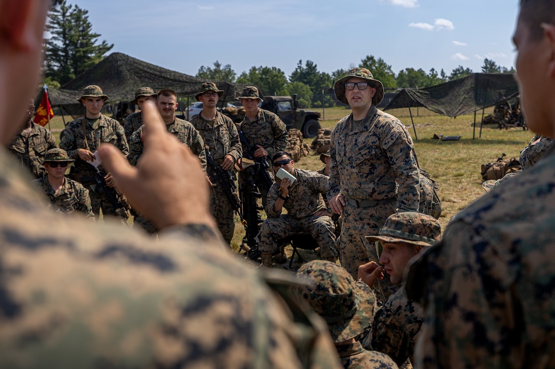 U.S. Marine Corps Staff Sgt. Michael Schram, a squad leader with Rifle Company, 1st Battalion, 24th Marine Regiment, 4th Marine Division, gives a brief on the offensive raid training event for training exercise Northern Strike 25-2 at Camp Grayling, Michigan, Aug. 9, 2025. Northern Strike, held Aug. 2 to 16, 2025, is designed to validate readiness of Joint Reserve forces at the National All-Domain Warfighting Center. This year's iteration featured approximately 7,500 participants. (U.S. Marine Corps photo by Cpl. Aaron TorresLemus)