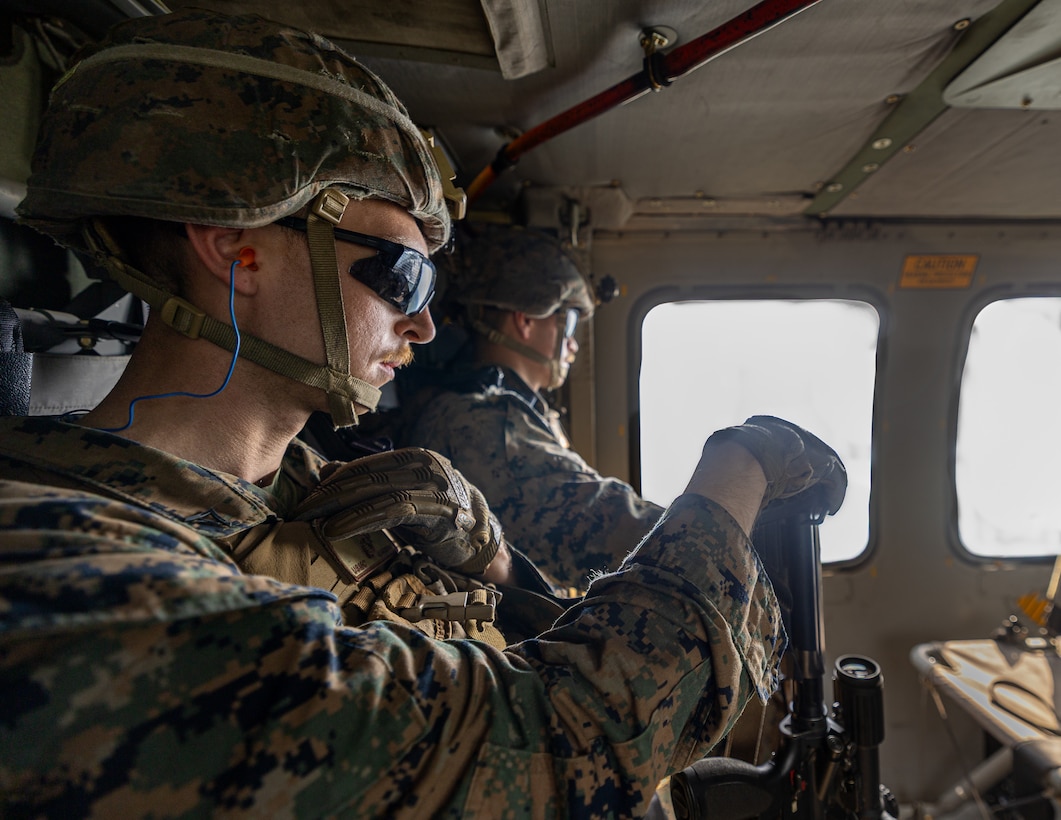 U.S. Marine Corps Lance Cpl. Ryan Finnerty, left and Cpl. Tavin Leist-Durall, riflemen with Charlie Company, 1st Battalion, 24th Marine Regiment, 4th Marine Division, ride on an U.S. Army Sikorsky UH-60 Black Hawk to conduct an offensive raid training event for training exercise Northern Strike 25-2 at Camp Grayling, Michigan, Aug. 9, 2025. Northern Strike, held Aug. 2 to 16, 2025, is designed to validate readiness of Joint Reserve forces at the National All-Domain Warfighting Center. This year's iteration featured approximately 7,500 participants. (U.S. Marine Corps photo by Cpl. Aaron TorresLemus)