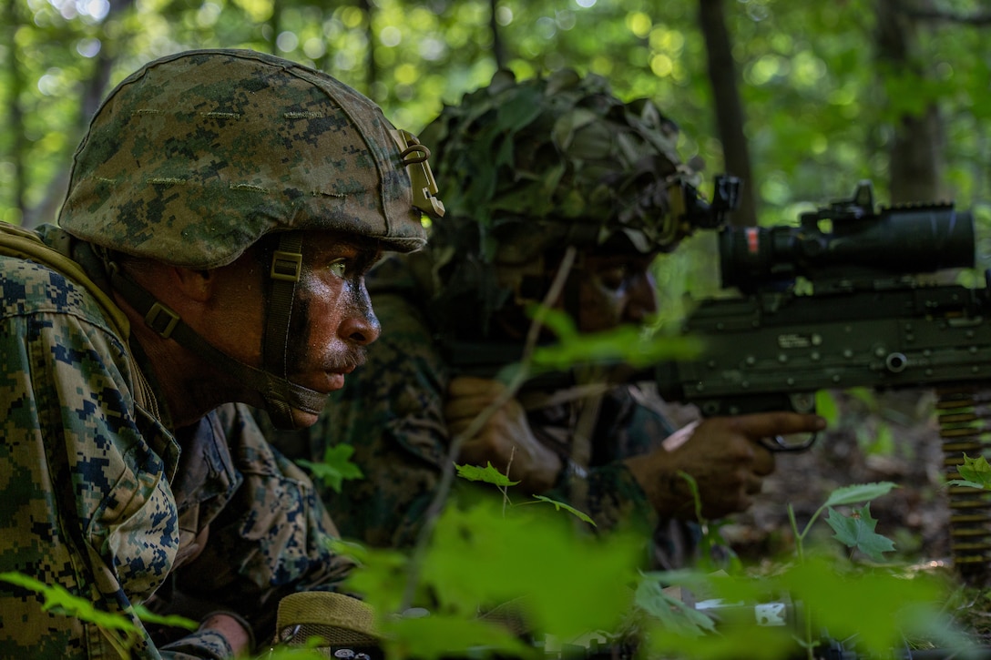 U.S. Marine Corps Cpl. Calvin Burdick, left, and Lance Cpl. Ahmed Alsawafy,  machine gunners with Charlie Company, 1st Battalion, 24th Marine Regiment, 4th Marine Division, await the signal to begin the attack during an offensive raid training event for training exercise Northern Strike 25-2 at Camp Grayling, Michigan, Aug. 9, 2025. Northern Strike, held Aug. 2 to 16, 2025, is designed to validate readiness of Joint Reserve forces at the National All-Domain Warfighting Center. This year's iteration featured approximately 7,500 participants. (U.S. Marine Corps photo by Cpl. Aaron TorresLemus)