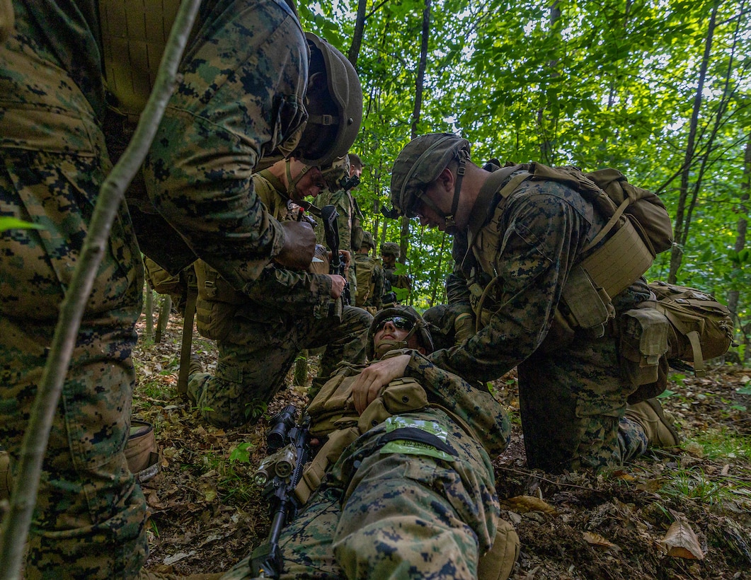 U.S. Marines with Charlie Company, 1st Battalion, 24th Marine Regiment, 4th Marine Division, provide aid to a simulated casualty during an offensive raid training event for training exercise Northern Strike 25-2 at Camp Grayling, Michigan, Aug. 9, 2025. Northern Strike, held Aug. 2 to 16, 2025, is designed to validate readiness of Joint Reserve forces at the National All-Domain Warfighting Center. This year's iteration featured approximately 7,500 participants. (U.S. Marine Corps photo by Cpl. Aaron TorresLemus)
