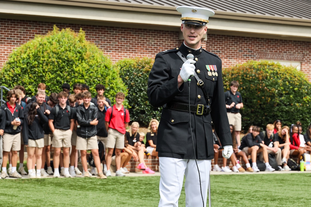 U.S. Marine Corps Capt. Ford Higgins, platoon commander with the United States Marine Corps Silent Drill Platoon, Marine Barracks Washington, speaks with students and civilians attending a performance at Greater Atlanta Christian High School during Marine Week Atlanta in Norcross, Ga., Aug. 28, 2025. The year 2025 marks the 250th anniversary of the United States Marine Corps, a milestone that highlights the legacy, transformation and enduring spirit of the Corps since 1775. Throughout the year, Marines across the globe will commemorate this anniversary by honoring the service and sacrifice of those who served before them and by remaining faithful to the motto Semper Fidelis. (U.S. Marine Corps photo by Cpl. Christopher Prelle)