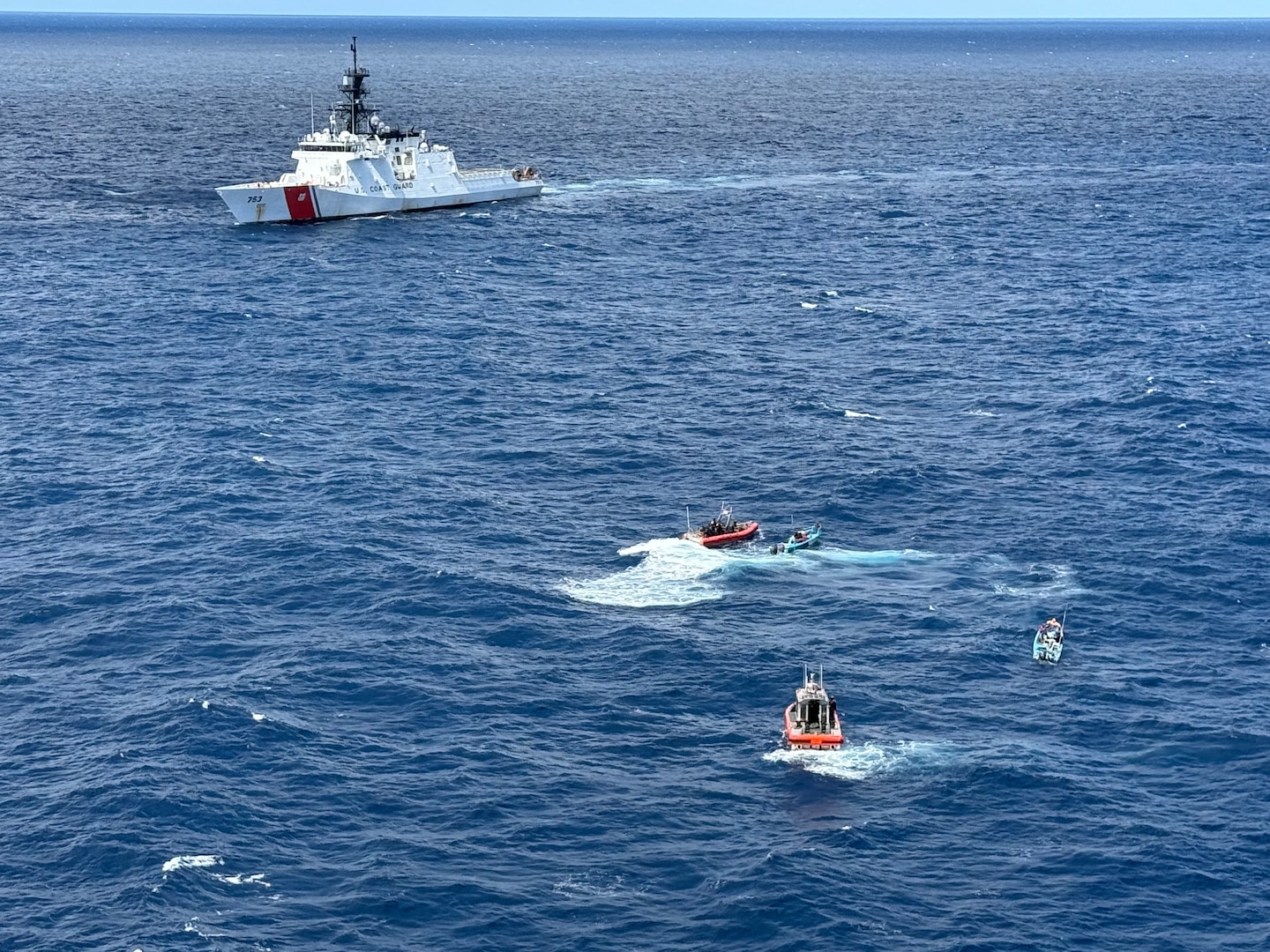 U.S. Coast Guard Cutter Hamilton (WMSL 753) boarding team interdicting two go-fast vessels suspected of drug smuggling approximately 115 miles southeast of the Galapagos Islands, Ecuador, June 26, 2025. The vessels were initially detected by a maritime patrol aircraft, and Hamilton’s embarked Helicopter Interdiction Tactical Squadron (HITRON) aircrew provided airborne tactical support, resulting in the seizure of more than 4,475 pounds of cocaine. (U.S. Coast Guard photo)