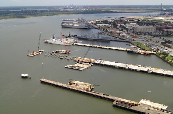 Reconstruction of Pier November (second from the bottom) continues July 23, 2025, at Base Charleston in North Charleston, South Carolina. The Coast Guard used funding made available under the One Big Beautiful Bill Act to modify an existing contract to remove submerged pilings in the vicinity of the piers to facilitate construction of new and modernized facilities to support Coast Guard major cutter operations. U.S. Coast Guard photo.