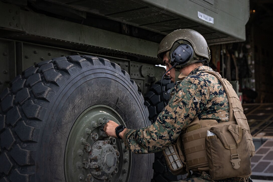 U.S. Marine Corps Lance Cpl. Tristan Coriz, a High Mobility Artillery Rocket System (HIMARS) operator, with 2nd Battalion, 14th Marine regiment, 4th Marine Division, prepares a HIMARS for transport to a training site during ARCTIC EDGE 2025 (AE25) at Joint Base Elmendorf-Richardson, Alaska, Aug. 19th, 2025. Specialized Arctic training generates valuable lessons learned for warfighters and enablers ensuring they can execute their assigned missions in any environment. AE25 is a NORAD and U.S. Northern Command-led homeland defense exercise designed to improve readiness, demonstrate capabilities and enhance Joint and Allied Force interoperability in the Arctic. (U.S. Marine Corps Photo by Lance Cpl. Edward Spears)