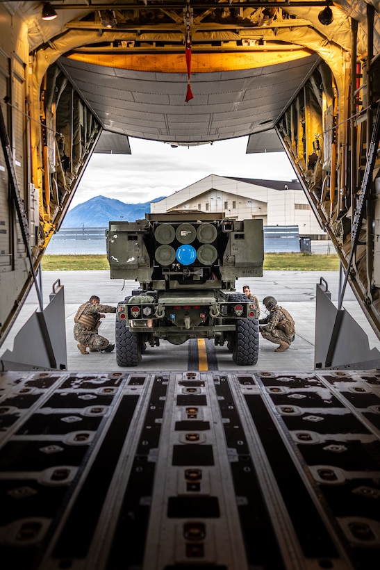 U.S. Marines with 2nd Battalion, 14th Marine regiment, 4th Marine Division, prepare a High Mobility Artillery Rocket System (HIMARS) for transport to a training site during ARCTIC EDGE 2025 (AE25) at Joint Base Elmendorf-Richardson, Alaska, Aug. 19th, 2025. Specialized Arctic training generates valuable lessons learned for warfighters and enablers ensuring they can execute their assigned missions in any environment. AE25 is a NORAD and U.S. Northern Command-led homeland defense exercise designed to improve readiness, demonstrate capabilities and enhance Joint and Allied Force interoperability in the Arctic. (U.S. Marine Corps Photo by Lance Cpl. Edward Spears)