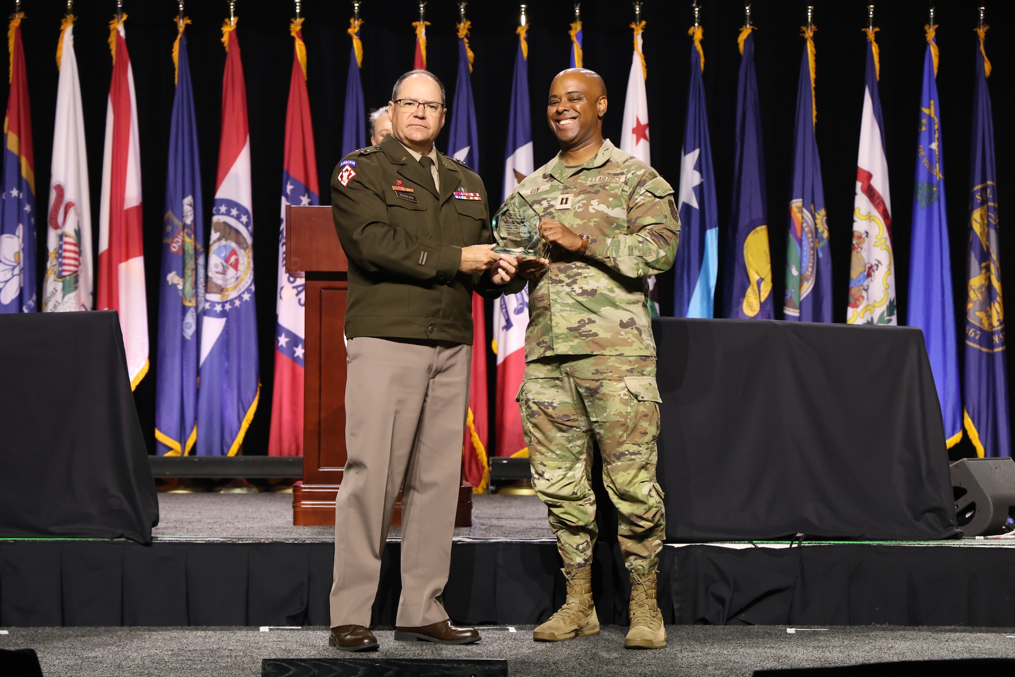 U.S. Army National Guard Maj. Gen. Paul Rogers, chairman of the board for the National Guard Association of the United States, presents the Theodore Roosevelt Leadership Award for Company Grade Officers to Maryland Air National Guard Capt. Kerry T. Guy, 175th Wing base contracting officer, at the 147th National Guard Association of the United States General Conference and Exhibition at the Baird Center in Milwaukee, August 24, 2025. This annual award honors outstanding Army and Air National Guard junior officers for exceptional service, leadership and professionalism to their country and community. (Courtesy Photo by Drake Sorey)