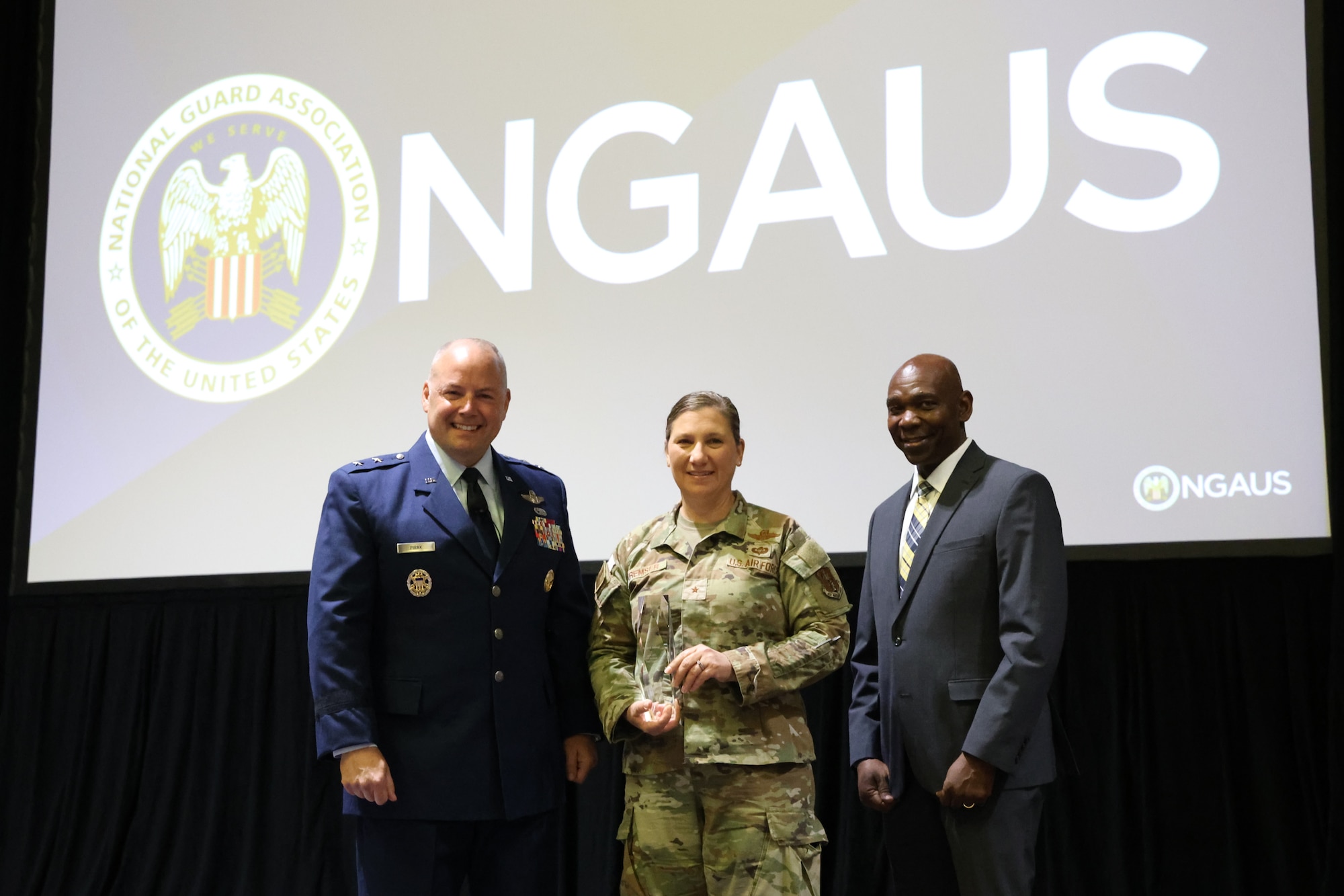 U.S. Air National Guard Maj. Gen. Duke A. Pirak (left), acting director of the Air National Guard and Maj. Gen. (retired) Ondra Berry (right), vice chair-Air of the National Guard Association of the United States, presents the Air National Guard Spaatz Trophy to Maryland Air National Guard Brig. Gen. Amy P. Kremser (middle), director of joint staff for the Maryland National Guard, at the 147th National Guard Association of the United States General Conference and Exhibition at the Baird Center in Milwaukee, August 25, 2025. The 175th Wing was awarded the Air National Guard Spaatz Trophy, presented in honor of Gen. Carl A. Spaatz, the first Chief of Staff of the U.S. Air Force. (Courtesy Photo by Drake Sorey)