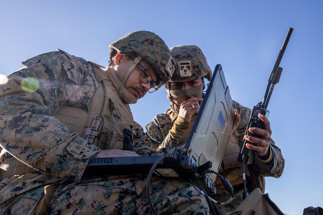 U.S. Marine Corps Sgt. Deiondre Ford, left, and Cpl. Juan Barragan, communication specialist, with 7th Marine Regiment, 1st Marine Division, coordinate a fire drill during High Mobility Artillery Rocket System (HIMARS) training as part of ARCTIC EDGE 2025 (AE25) at Kotzebue, Alaska, Aug. 19th, 2025. Specialized Arctic training generates valuable lessons learned for warfighters and enablers ensuring they can execute their assigned missions in any environment. AE25 is a NORAD and U.S. Northern Command-led homeland defense exercise designed to improve readiness, demonstrate capabilities and enhance Joint and Allied Force interoperability in the Arctic. (U.S. Marine Corps Photo by Lance Cpl. Edward Spears)