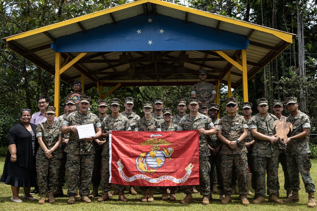 U.S. Marines with Combat Logistics Battalion 15, Combat Logistics Regiment 17, 1st Marine Logistics Group, and staff from the Pohnpei Public Library pose for a photo during Koa Moana 25 at Pohnpei Public Library on Pohnpei, Federated States of Micronesia, Sept. 1, 2025.