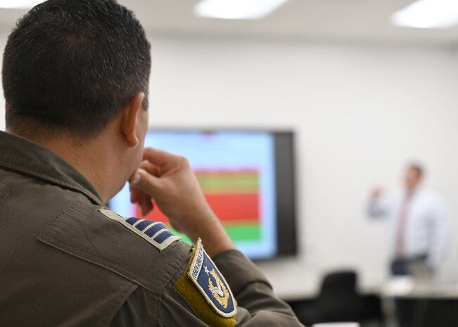 Chilean Air Force Col. Ignacio Baeza, FACh foreign liaison officer, actively listens to a brief during the 2025 Airman-to-Airman Talks at Davis-Monthan Air Force Base, Arizona, Aug. 27, 2025. The A2A Talks allowed the Chilean Air Force to share their cooperation goals and priorities, drive planned engagements and advance partnership objectives with the U.S. (U.S. Air Force photo by Staff Sgt. Abbey Rieves)