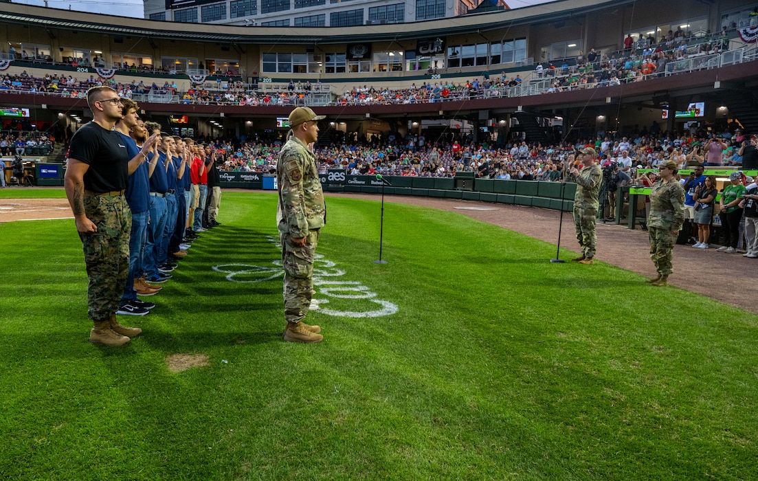 Col. Dustin Richards, 88th Air Base Wing and Installation Commander, delivers the oath of enlistment to recruits part of the Delayed Entry Program during the Dayton Dragons American Celebration Night at Dayton Air Ballpark Aug. 23, 2025.  Members of the military also threw out the ceremonial first pitch and presented the colors during the pregame ceremonies. (U.S. Air Force photo by Jack Gardner)
