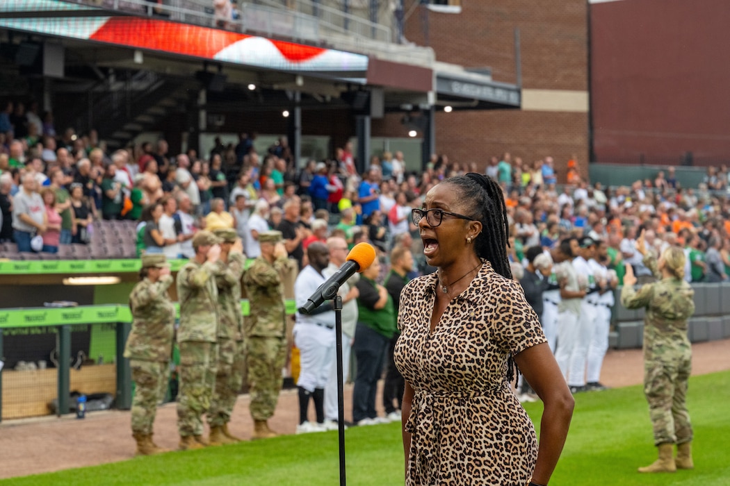 Felita LaRock sings the National Anthem to kick off the Dayton Dragons American Celebration Night game at Dayton Air Ballpark Aug. 23, 2025. In addition to throwing out the pitch, 30 individuals took the oath of enlistment to delayed enlistment personnel during the game. (U.S. Air Force photo by Jack Gardner)