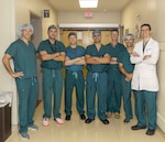 The Skull Base Team at Walter Reed National Military Medical Center gathers outside the operating room before surgery on August 15. The Skull Base Team is a collaborative, multidisciplinary group of specialists who treat some of the most complex head, neck and skull base tumors. (DOD photo by Roan Smith)