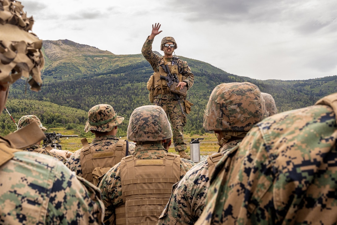 U.S. Marine Corps Staff Sgt. Jesus Limon, platoon sergeant, with 2nd Battalion, 14th Marine regiment, 4th Marine Division, gives a range safety brief during range training at ARTIC EDGE 2025 (AE25), at Joint Base Elmendorf-Richardson, Alaska, Aug. 16th, 2025. Specialized Arctic training generates valuable lessons learned for warfighters and enablers ensuring they can execute their assigned missions in any environment. AE25 is a NORAD and U.S. Northern Command-led homeland defense exercise designed to improve readiness, demonstrate capabilities and enhance Joint and Allied Force interoperability in the Arctic. (U.S. Marine Corps Photo by Lance Cpl. Edward Spears)