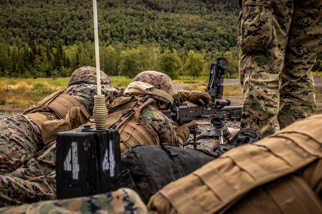 U.S. Marines with 2nd Battalion, 14th Marine regiment, 4th Marine Division, load a M240 during range familiarization training as part of ARCTIC EDGE 2025 (AE25), at Joint Base Elmendorf-Richardson, Alaska, Aug. 16th, 2025. Specialized Arctic training generates valuable lessons learned for warfighters and enablers ensuring they can execute their assigned missions in any environment. AE25 is a NORAD and U.S. Northern Command-led homeland defense exercise designed to improve readiness, demonstrate capabilities and enhance Joint and Allied Force interoperability in the Arctic. (U.S. Marine Corps Photo by Lance Cpl. Edward Spears)