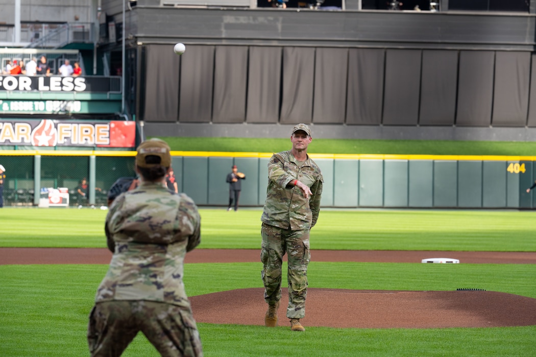Col. Dustin Richards, 88th Air Base Wing and Installation Commander, throws out the first pitch to wingman Chief Master Sgt. Tessa Fontaine, 88th Air Base Wing Command Chief, at Great American Ball Park, Aug. 29, 2025. The event was part of the Reds’ annual Military Appreciation Night. (U.S. Air Force photo by Jack Gardner)