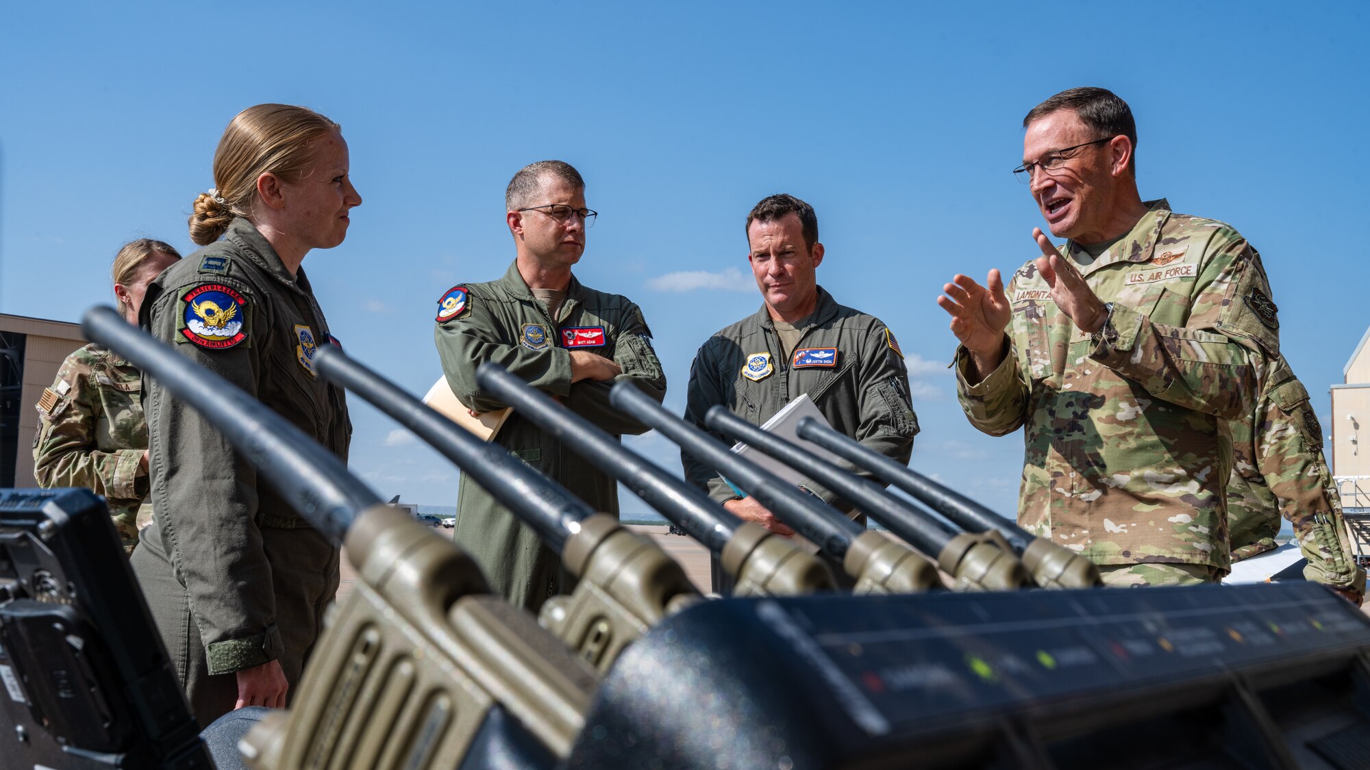 U.S. Air Force Capt. Shannon Hunter, 39th Airlift Squadron pilot, discusses a mobile Tactical Operations Center (TOC) with Gen. Johnny Lamontagne, Air Mobility Command commander, during a tour at Dyess Air Force Base, Texas, Aug. 27, 2025. The TOC-in-a-box demonstration included the set-up of radio communications and secure internet protocol router network access. (U.S. Air Force photo by Senior Airman Jade M. Caldwell)