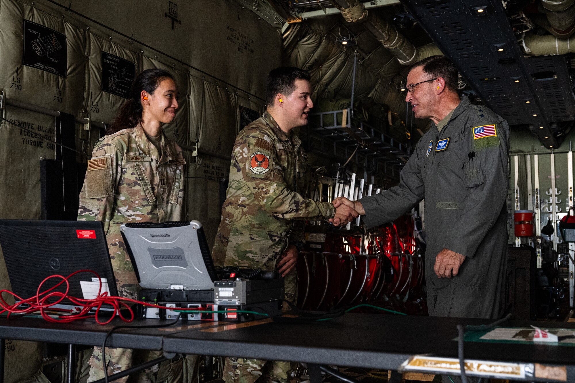 U.S. Air Force Senior Airman Juan Pablo De Alva, 317th Operations Support Squadron intelligence section lead, and Capt. Felicia Jones, 317th OSS intelligence assistant flight commander, demonstrate satellite communication capabilities to Gen. Johnny Lamontagne, Air Mobility Command commander, during a tour at Dyess Air Force Base, Texas, Aug. 26, 2025. Lamontagne flew with the 317th Airlift Wing on a C-130J Super Hercules and saw first-hand how the wing supports the command’s global rapid mobility mission. (U.S. Air Force photo by Senior Airman Jade M. Caldwell)