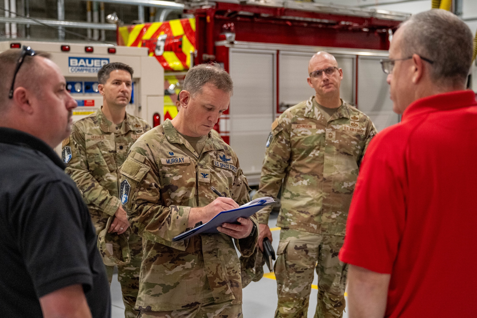 man signs papers at fire station