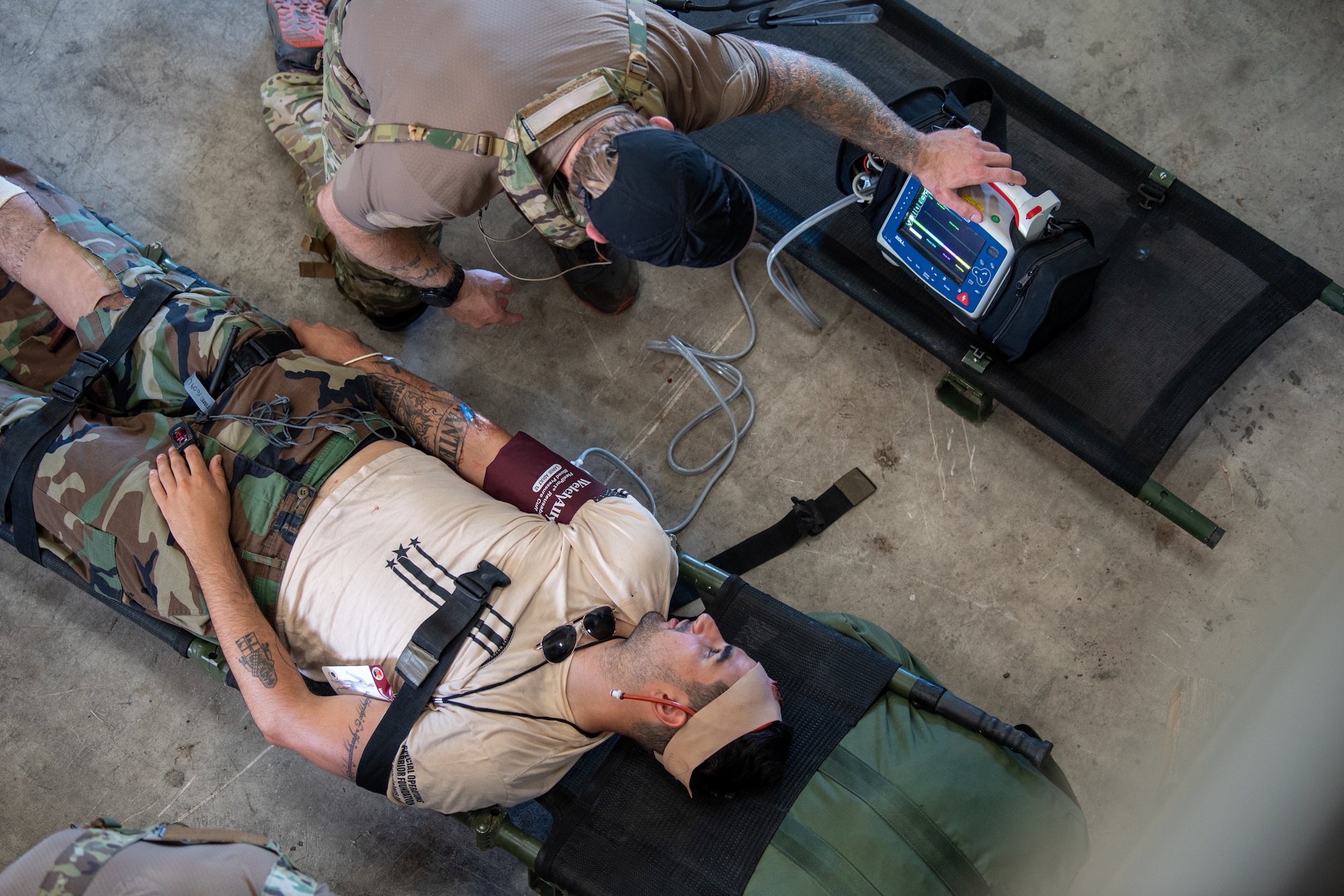 A U.S. Air Force special tactics Airman from the Kentucky Air National Guard’s 123rd Airlift Wing provides medical treatment to a role-player during a mass casualty exercise at the Virgin Islands Air National Guard Station in Christiansted, U.S. Virgin Islands, Aug. 29, 2025 as part of Emerald Warrior 25.2, a large-scale special operations exercise staged in multiple locations by Air Force Special Operations Command. After being stabilized, the patient was evacuated aboard a UH-60 Black Hawk from the Mississippi Army National Guard’s 185th Aviation Brigade. (U.S. Air National Guard photo illustration by Phil Speck)