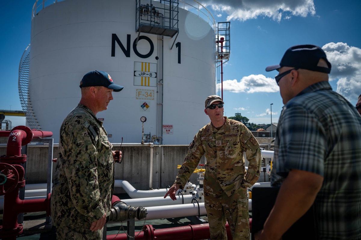 U.S. Navy Chief Adam Bryan, left, Naval Defense Fuel Service Point Hachinohe general manager, U.S. Air Force Senior Master Sergeant Roger Halle, center, 35th Civil Engineer Squadron fire chief, and U.S. Navy Arthur Navarro, Defense Fuel Supply Point Hachinohe fuels director, discuss and inspect connection points prior to conducting a fuel tank fire drill at Hachinohe City, Japan, Sept. 3, 2025.