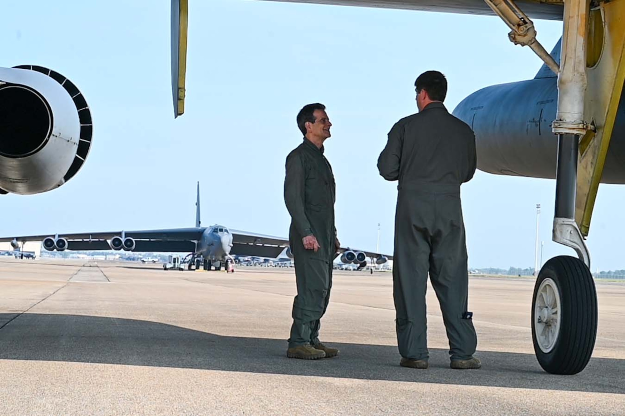 Men talk outside a B-52