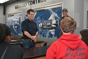 Man speaks with students
