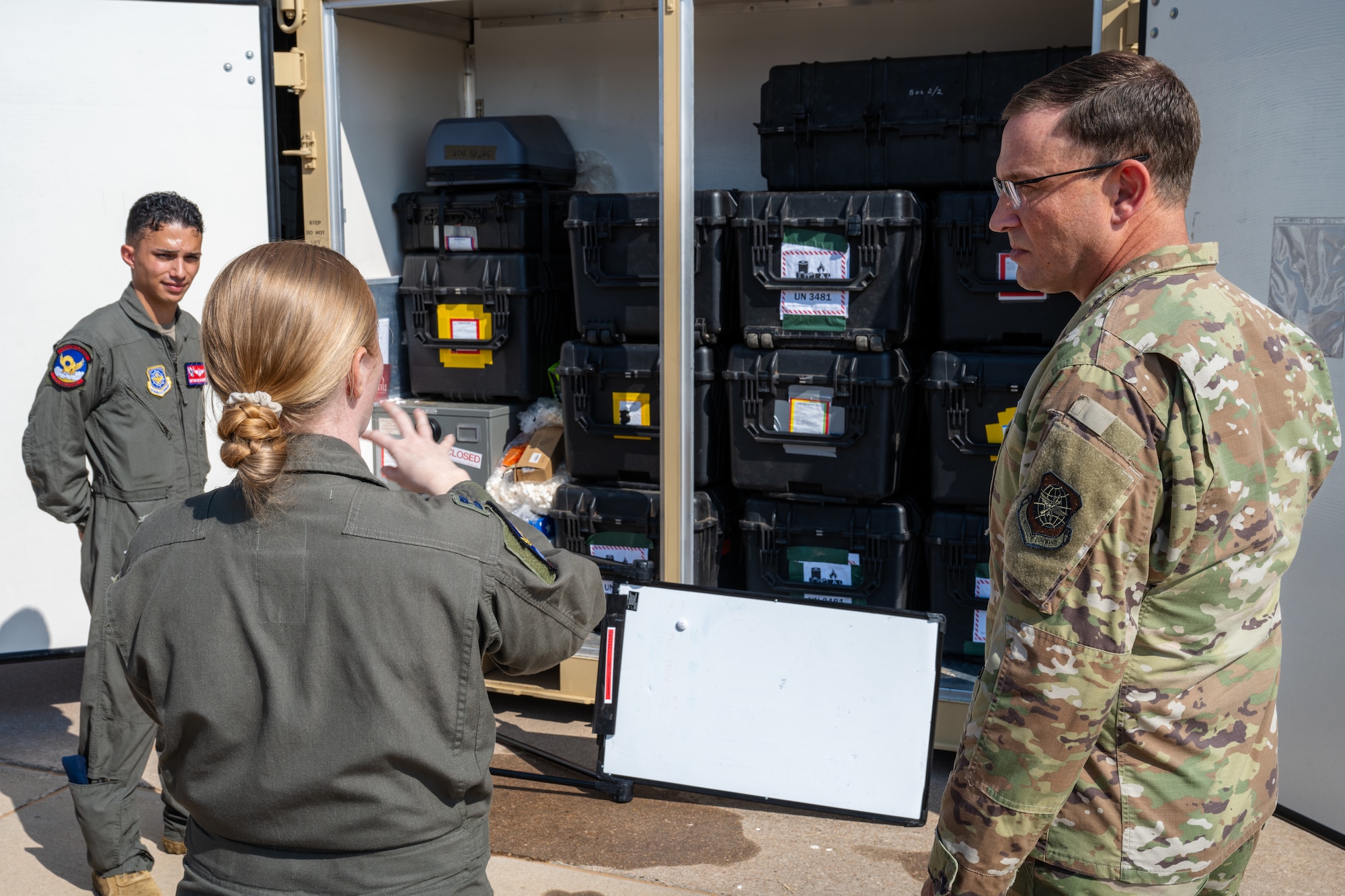 U.S. Air Force Capt. Shannon Hunter, 39th Airlift Squadron pilot, briefs Gen. Johnny Lamontagne, Air Mobility Command commander, on a mobile Tactical Operations Center (TOC) during a tour at Dyess Air Force Base, Texas, Aug. 27, 2025. TOC-in-a-Box is a modular, roll-on/roll-off package that enables flexible command and control in austere or forward locations without permanent infrastructure. (U.S. Air Force photo by Senior Airman Jade M. Caldwell)