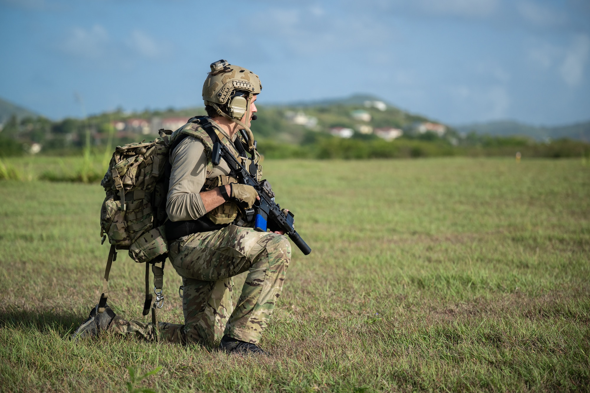 A U.S. Air Force special tactics Airman from the Kentucky Air National Guard’s 123rd Airlift Wing provides perimeter security at Henry E. Rohlsen Airport near Christiansted in St. Croix, U.S. Virgin Islands, Aug. 26, 2025 as part of Emerald Warrior 25.2, a large-scale special operations exercise being staged in multiple locations by Air Force Special Operations Command. The Airman is among a group of combat controllers and pararescuemen who parachuted into the site minutes earlier to take control of  airfield operations. (U.S. Air National Guard photo by Dale Greer)