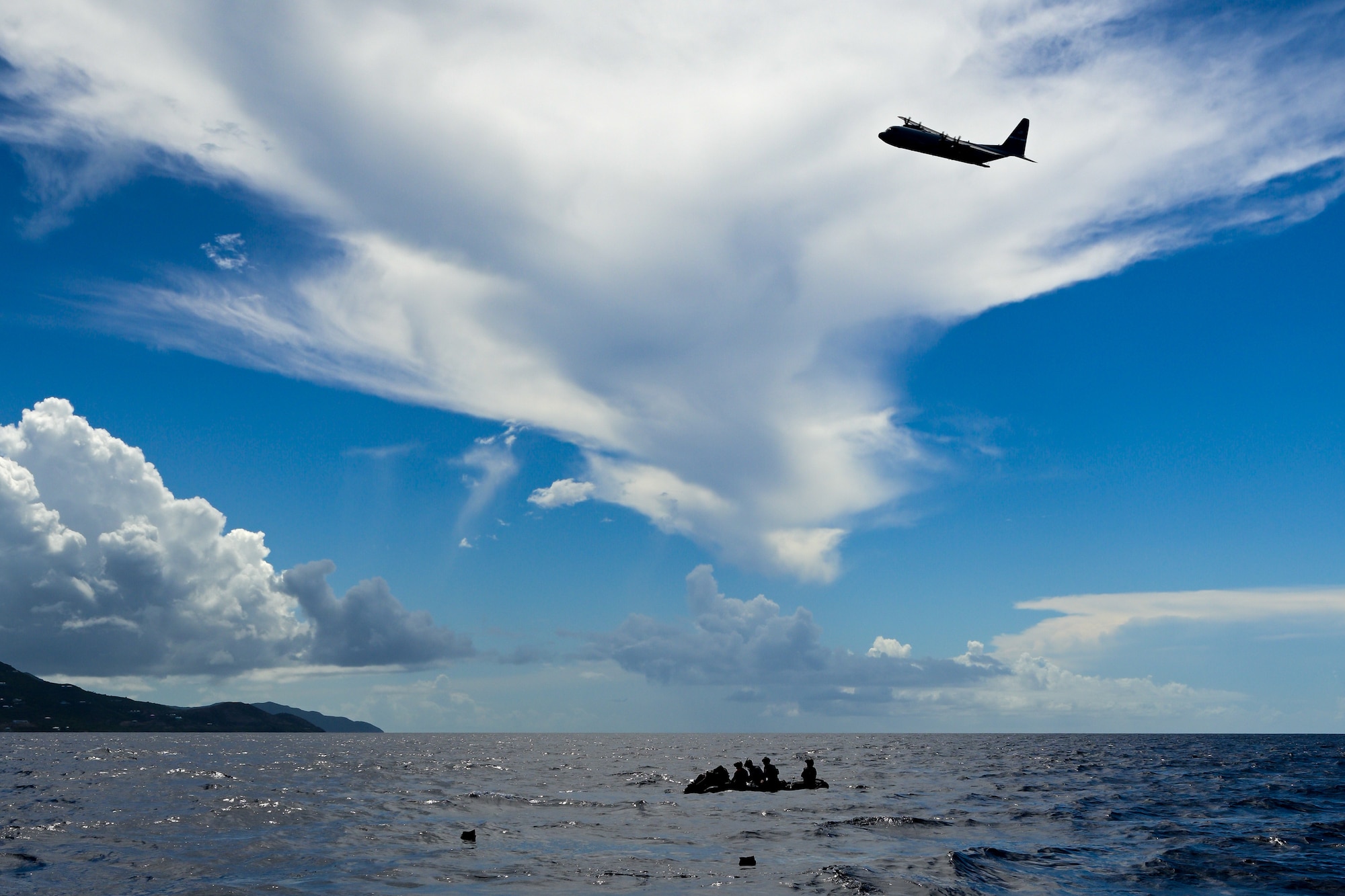 A U.S. Air Force C-130J Super Hercules from the Kentucky Air National Guard’s 123rd Airlift Wing monitors the unit’s special tactics Airmen as they execute a search-and-rescue mission in the Caribbean Sea off the coast of St. Croix, U.S. Virgin Islands, Aug. 29, 2025 as part of Emerald Warrior 25.2, a large-scale special operations exercise staged in multiple locations by Air Force Special Operations Command. St. Croix provides an ideal environment for testing littoral and maritime capabilities, simulating many of the geographic features that Airmen may encounter when deployed around the world to project air power in unfamiliar or contested environments. (U.S. Air National Guard photo by Dale Greer)