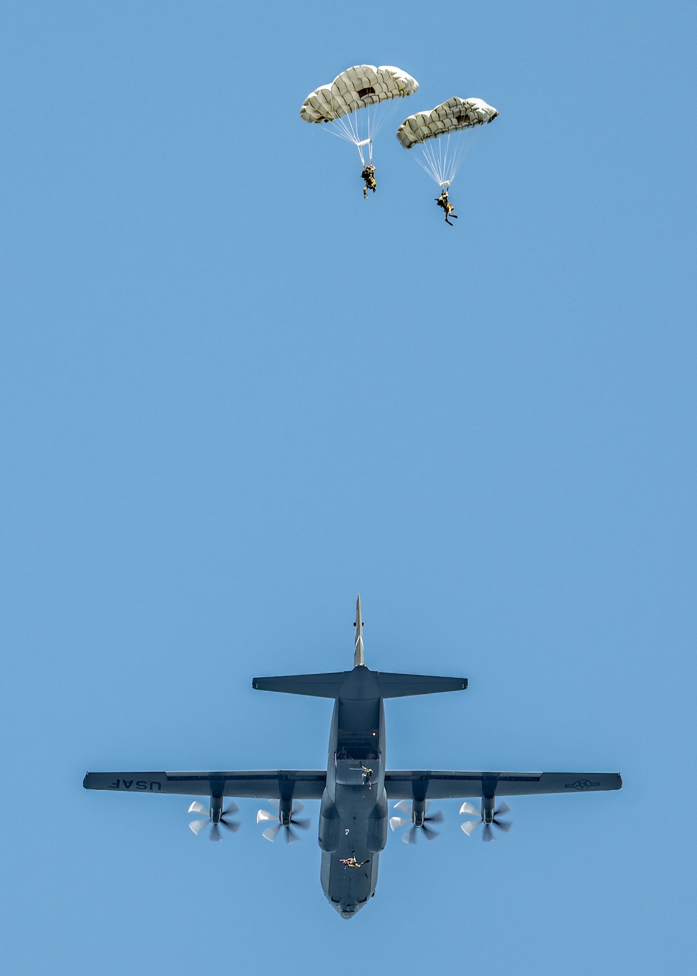 Four U.S. Air Force pararescuemen and combat controllers from the Kentucky Air National Guard’s 123rd Airlift Wing parachute from a C-130J Super Hercules into the Caribbean Sea to conduct a search-and-rescue mission for the survivors of a simulated plane crash off the coast of St. Croix, U.S. Virgin Islands, Aug. 29, 2025 as part of Emerald Warrior 25.2, a large-scale special operations exercise staged in multiple locations by Air Force Special Operations Command. St. Croix provides an ideal environment for testing littoral and maritime capabilities, simulating many of the geographic features that special operators may encounter when deployed around the world to project air power in unfamiliar or contested environments. (U.S. Air National Guard photo by Dale Greer)