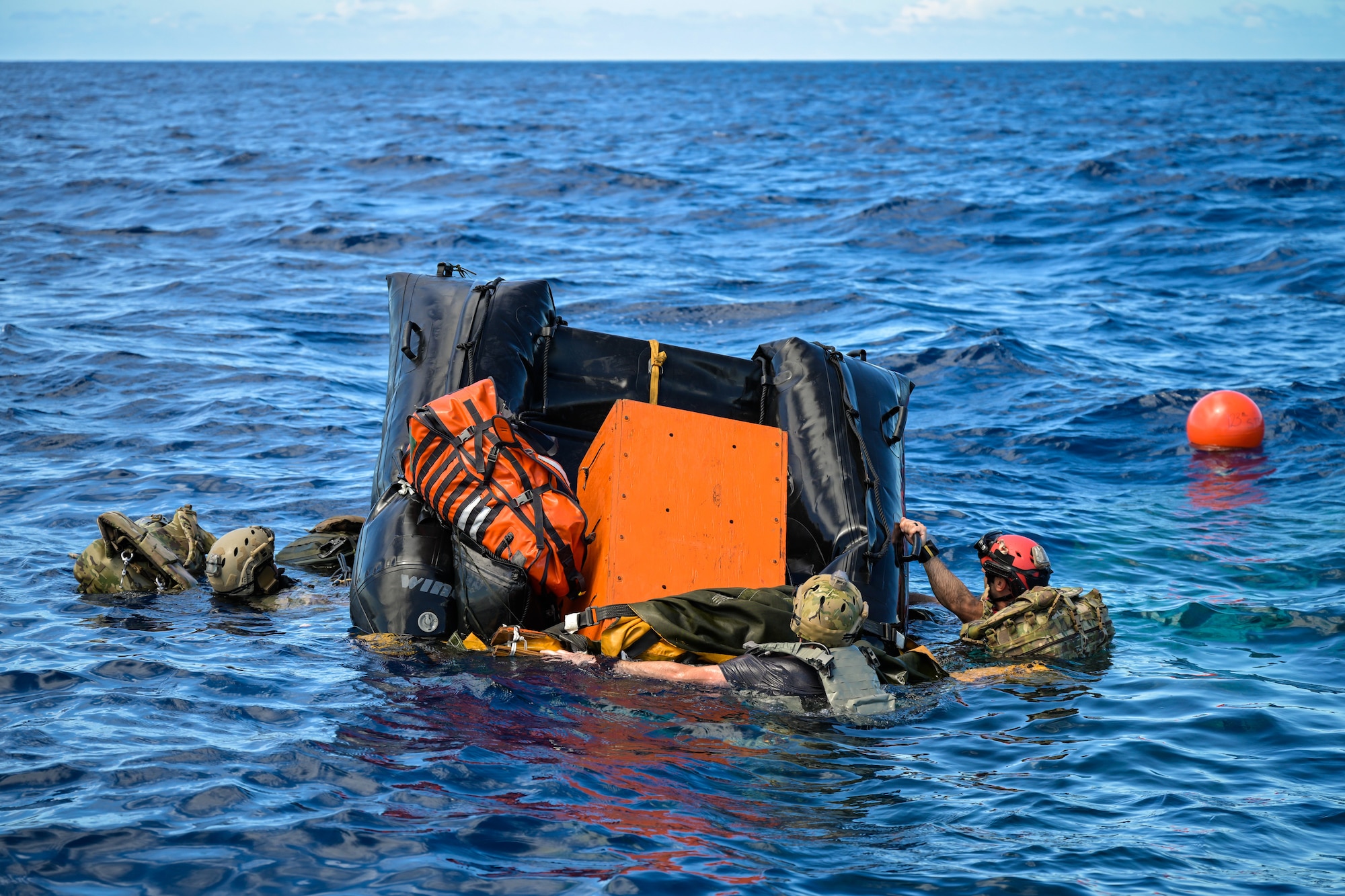 U.S. Air Force special tactics Airmen from the Kentucky Air National Guard’s 123rd Airlift Wing unpack an inflatable boat bundle for a search-and-rescue mission after parachuting into the Caribbean Sea off the coast of St. Croix, U.S. Virgin Islands, Aug. 29, 2025 as part of Emerald Warrior 25.2, a large-scale special operations exercise staged in multiple locations by Air Force Special Operations Command. St. Croix provides an ideal environment for testing littoral and maritime capabilities, simulating many of the geographic features that special operators may encounter when deployed around the world to project air power in unfamiliar or contested environments. (U.S. Air National Guard photo by Dale Greer)