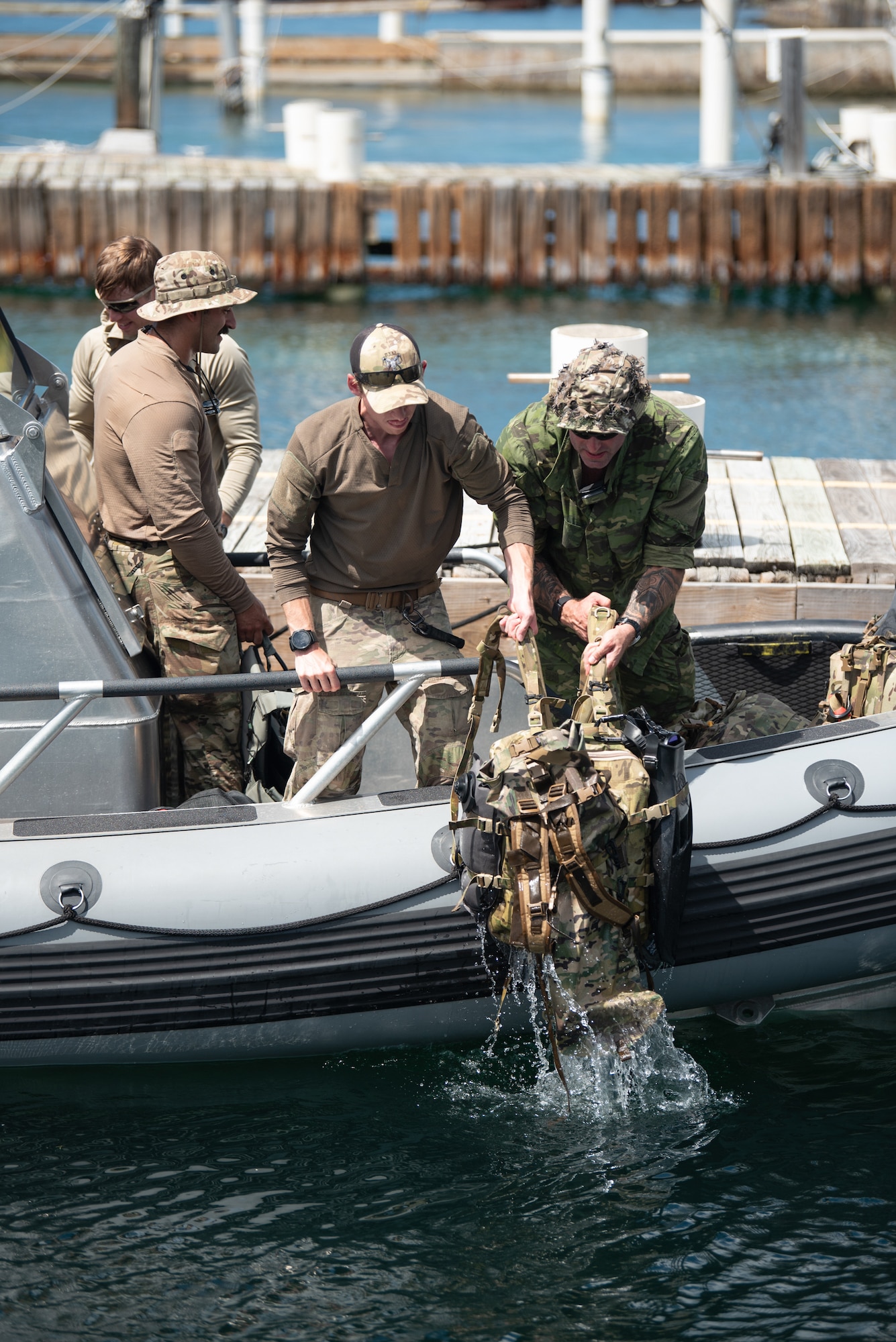 U.S. Air Force special tactics Airmen from the Kentucky Air National Guard’s 123rd Airlift Wing test bags for buoyancy and leaks in Christiansted Harbor, U.S. Virgin Islands, before conducting a reconnaissance mission on another island 75 nautical miles away Aug. 27, 2025 as part of Emerald Warrior 25.2, a large-scale special operations exercise staged in multiple locations by Air Force Special Operations Command. The Caribbean provides an ideal environment for testing the unit’s littoral and maritime capabilities, simulating many of the geographic features that special operators may encounter when deployed around the world to project air power in unfamiliar or contested environments. (U.S. Air National Guard photo by Phil Speck)
