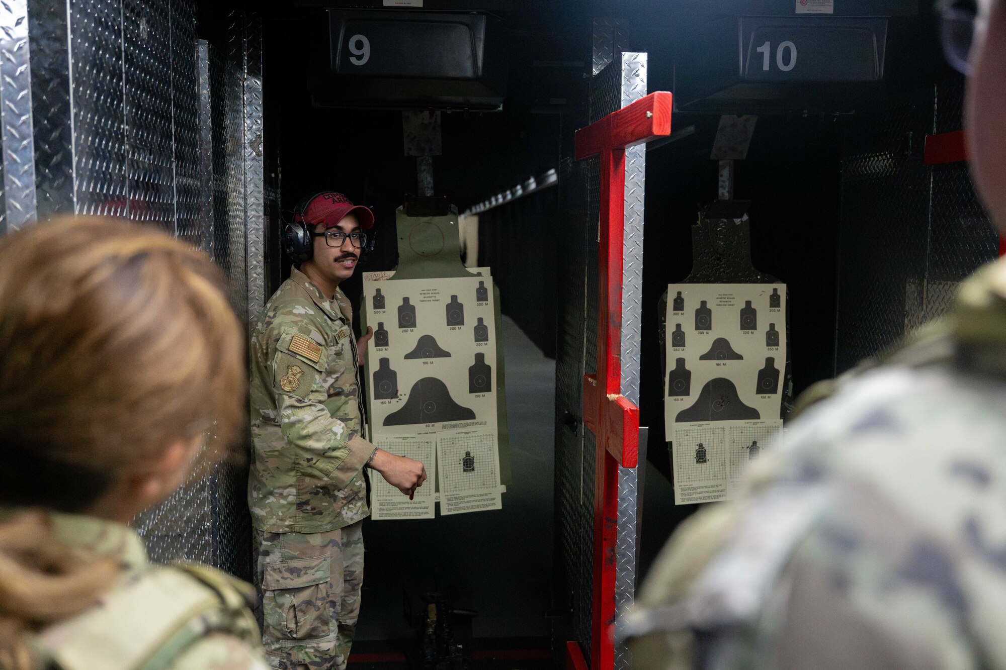 A U.S. Air Force Airmen instructs security forces defenders where to shoot the target in the shooting range on Joint Base Pearl Harbor-Hickam, Hawaii.