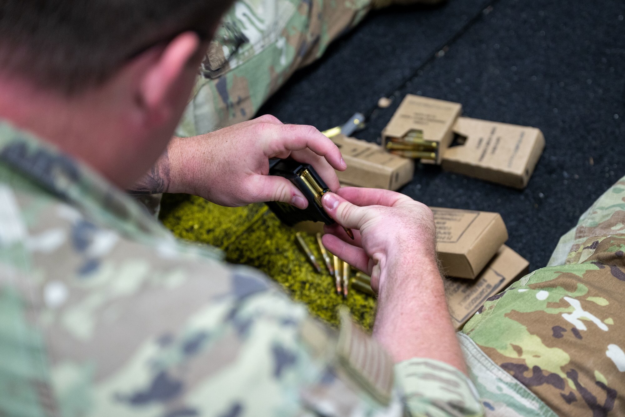 A U.S. Air Force Airmen loads rounds into an M4 carbine magazine prior to shooting at the range on Joint Base Pearl Harbor-Hickam, Hawaii.