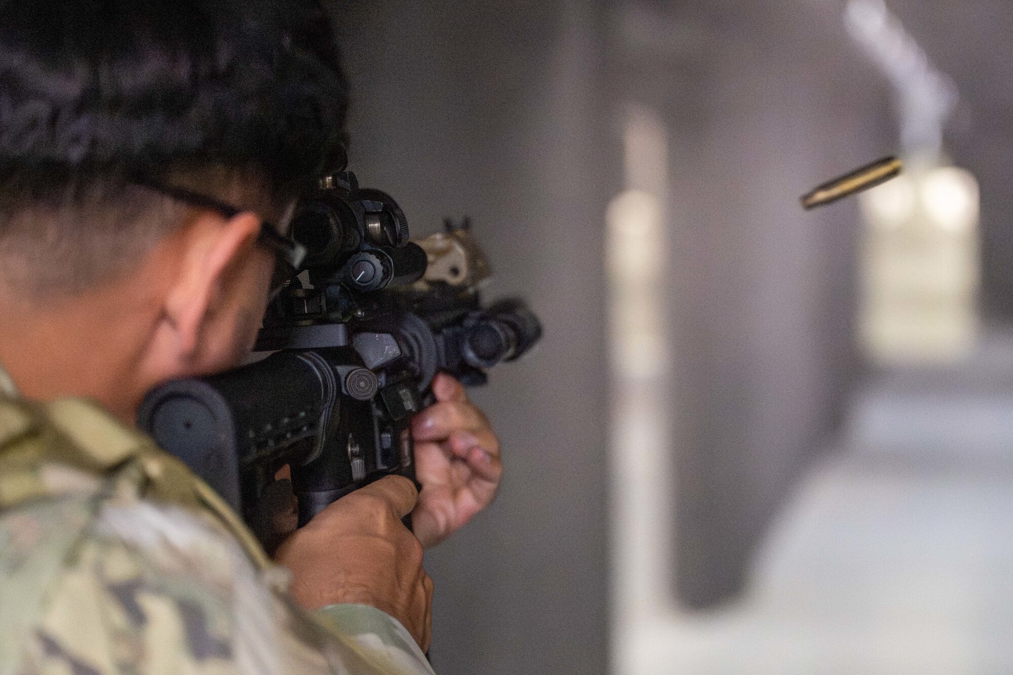 A U.S. Air Force Airmen shoots an M4 carbine rifle during training on Joint Base Pearl Harbor-Hickam, Hawaii.