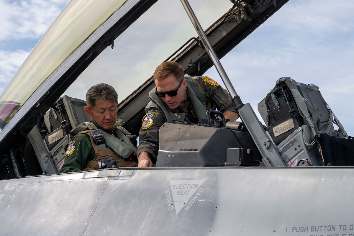 U.S. Air Force Col. Paul Davidson, right, 35th Fighter Wing commander, explains the controls of an F-16D Fighting Falcon’s cockpit to Japan Air Self-Defense Force Maj. Gen. Teruaki Fujita, 3rd Air Wing commander, before conducting an orientation flight at Misawa Air Base, Japan, Aug. 28, 2025.