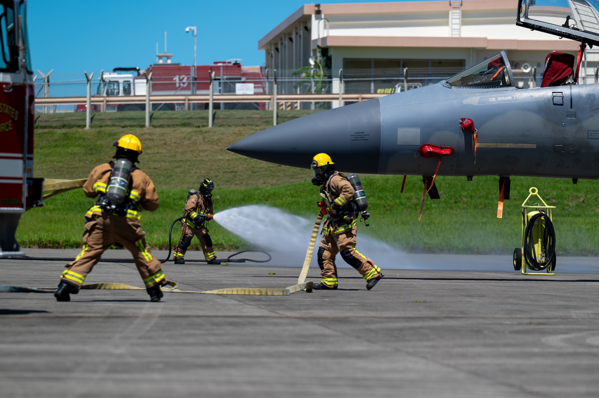 18 CES firefighters performing a simulated aircraft emergency exercise