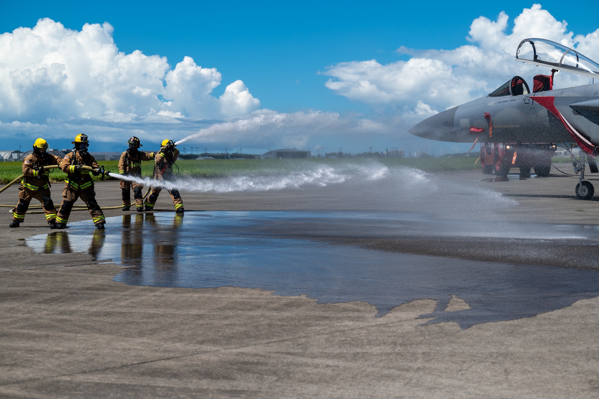 18 CES firefighters performing a simulated aircraft emergency exercise