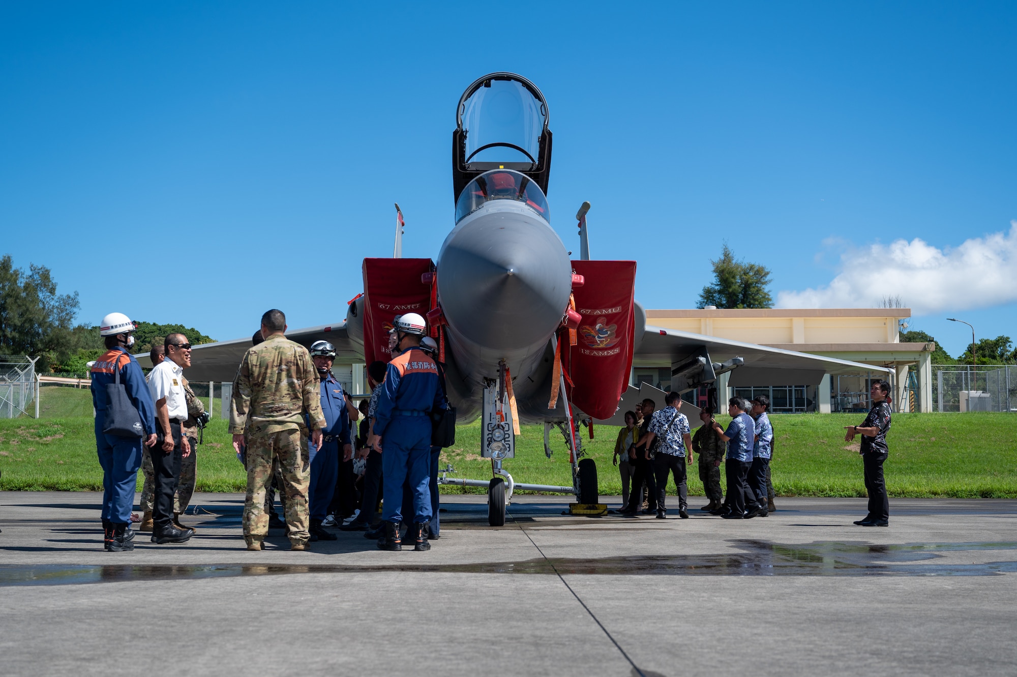Government of Japan officials and 18 CES Airmen inspecting an F-15C Eagle static display
