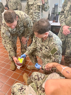 GUANTANAMO BAY, Cuba (July 24, 2025) – Hospital Corpsman 2nd Class Clayton VanStry collects fresh whole blood from a donor during tactical combat casualty care training at U.S. Naval Hospital Guantanamo Bay, July 24, 2025. Whole blood transfusion capability provides a critical life-saving option in combat and austere environments, directly supporting operational readiness. (U.S. Navy photo by Hospital Corpsman 2nd Class Shakirah Peterson-Wall)