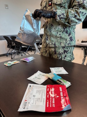 GUANTANAMO BAY, Cuba (August 28, 2025) – Hospital Corpsman 2nd Class Clayton VanStry opens a fresh whole blood transfusion set as he prepares to demonstrate a transfusion at U.S. Naval Hospital Guantanamo Bay, August 28, 2025. Whole blood transfusion capability provides a critical life-saving option in combat and austere environments, directly supporting operational readiness. (U.S. Navy photo by Emily McCamy)