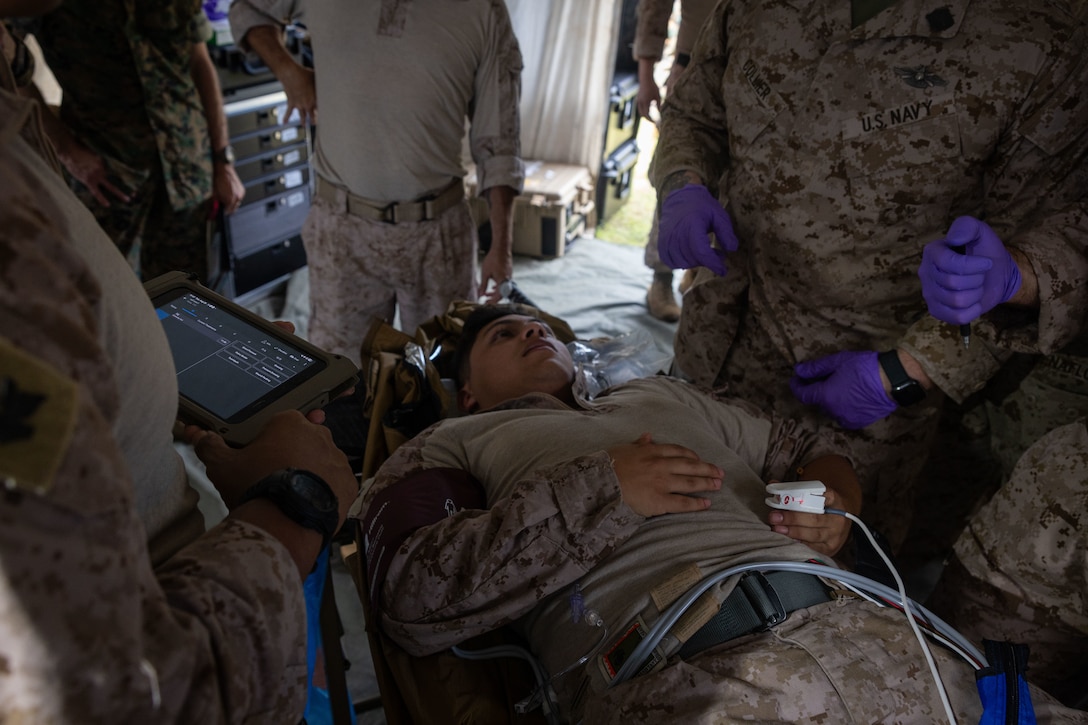 U.S. Navy Sailors with 2nd Medical Battalion, 2nd Marine Logistics Group, triage a simulated patient during a Battalion Aid Station-Enhanced (BAS-X) exercise at Marine Corps Base Camp Lejeune, North Carolina, Aug. 26, 2025.  The purpose of the exercise was to build a modernized BAS for the Marine Corps Warfighting Lab to inject into Fleet and Marine Corps exercises to support expeditionary advance base operations during combat operations. (U.S. Marine Corps photo by Sgt. Makayla Elizalde)