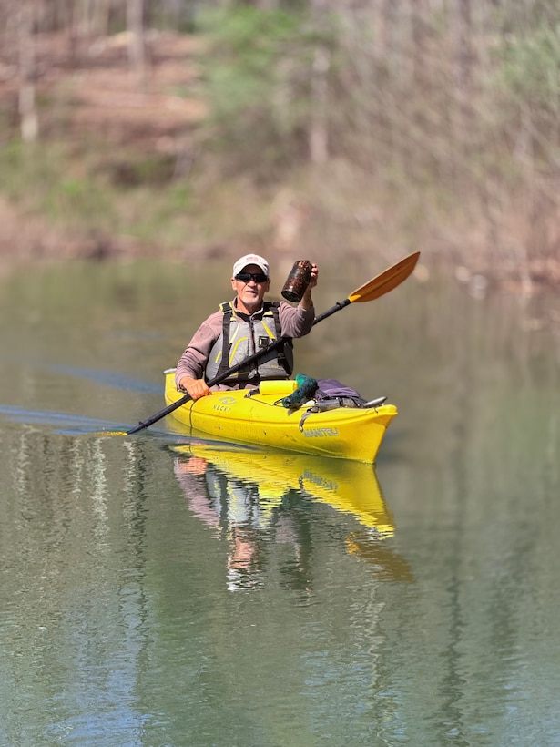 Kayak Ron holds up a rusted metal kerosene container discovered along the shoreline of Patoka Lake.