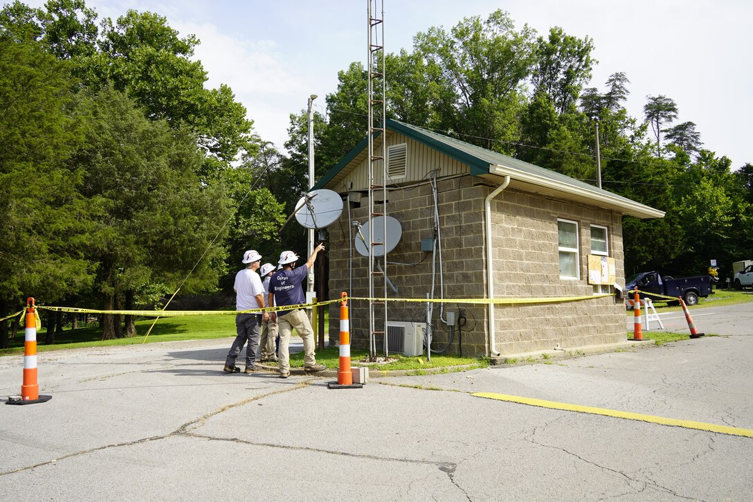 Nolin River Lake Maintenance Lead Kerry Sanders (right) and his team discuss plans to replace windows at a campground entrance station, July 21, 2025. The building was submerged for several weeks following record rainfall in early 2025.