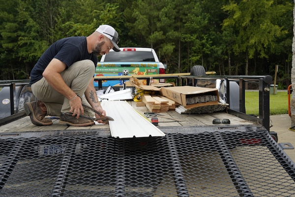 Barren River Lake’s Ryan Weaver prepares supplies to replace the ceiling of a campground restroom that was severely damaged by April’s flooding.